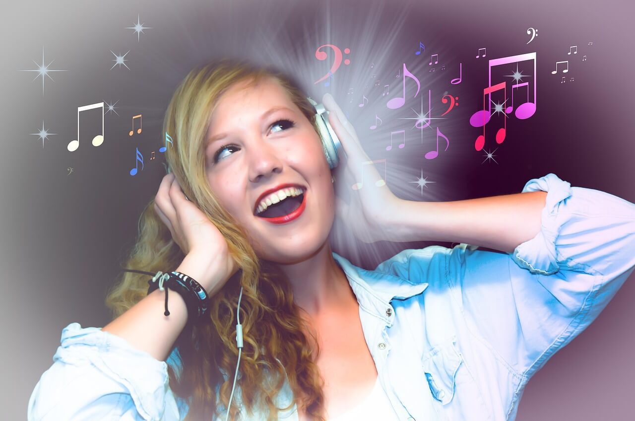 Giovane donna che ascolta musica con cuffie, immagine simbolica del legame tra musica e intelligenza.